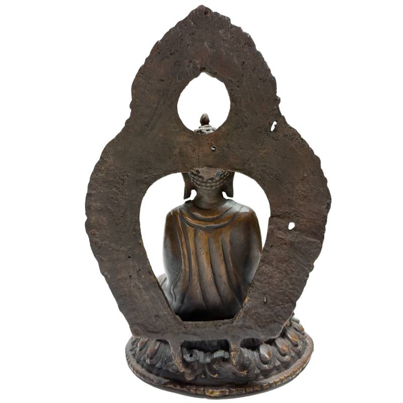 Rear view of Himalayan bronze Buddha with raised teaching gesture and aureole