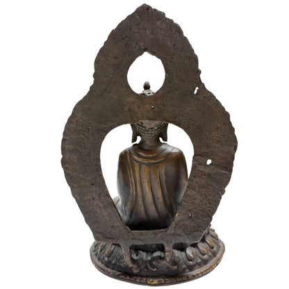 Rear view of Himalayan bronze Buddha with raised teaching gesture and aureole
