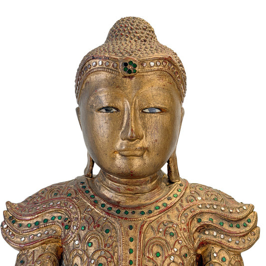 Inlaid eyes and facial detail of the antique Burmese Jambupati Buddha