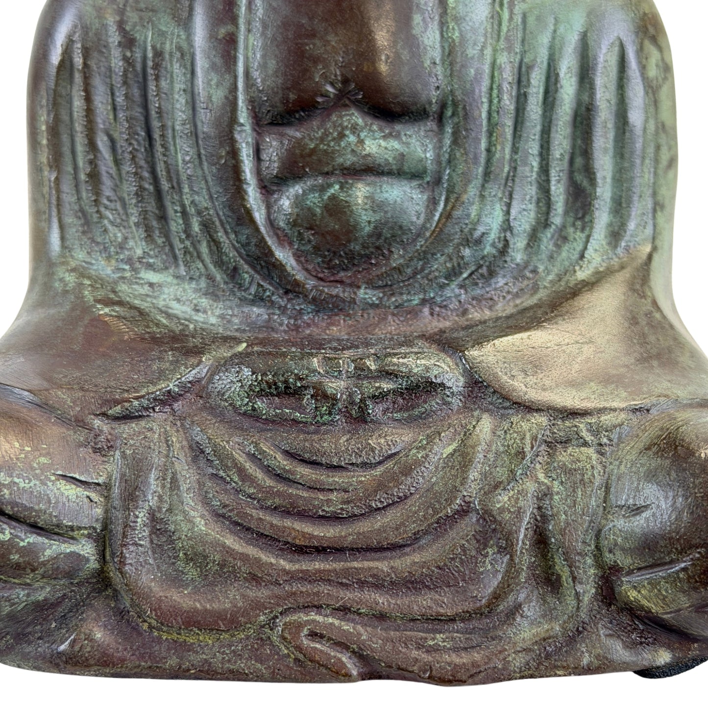Hands resting in Dhyana Mudra above the deeply folded robe of the bronze Buddha