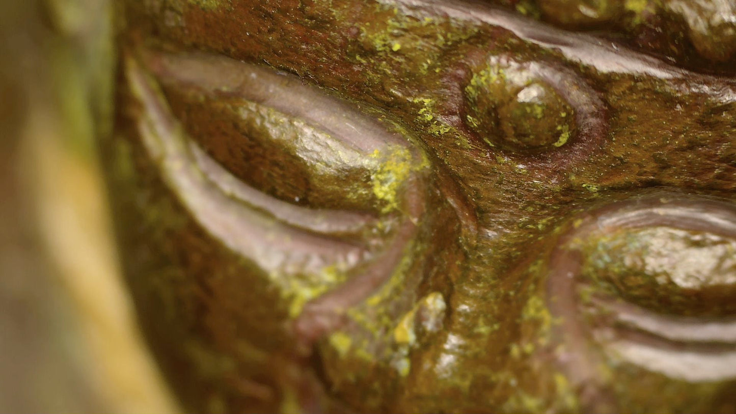 Macro photograph of the Buddha’s eye, urna and aged patina