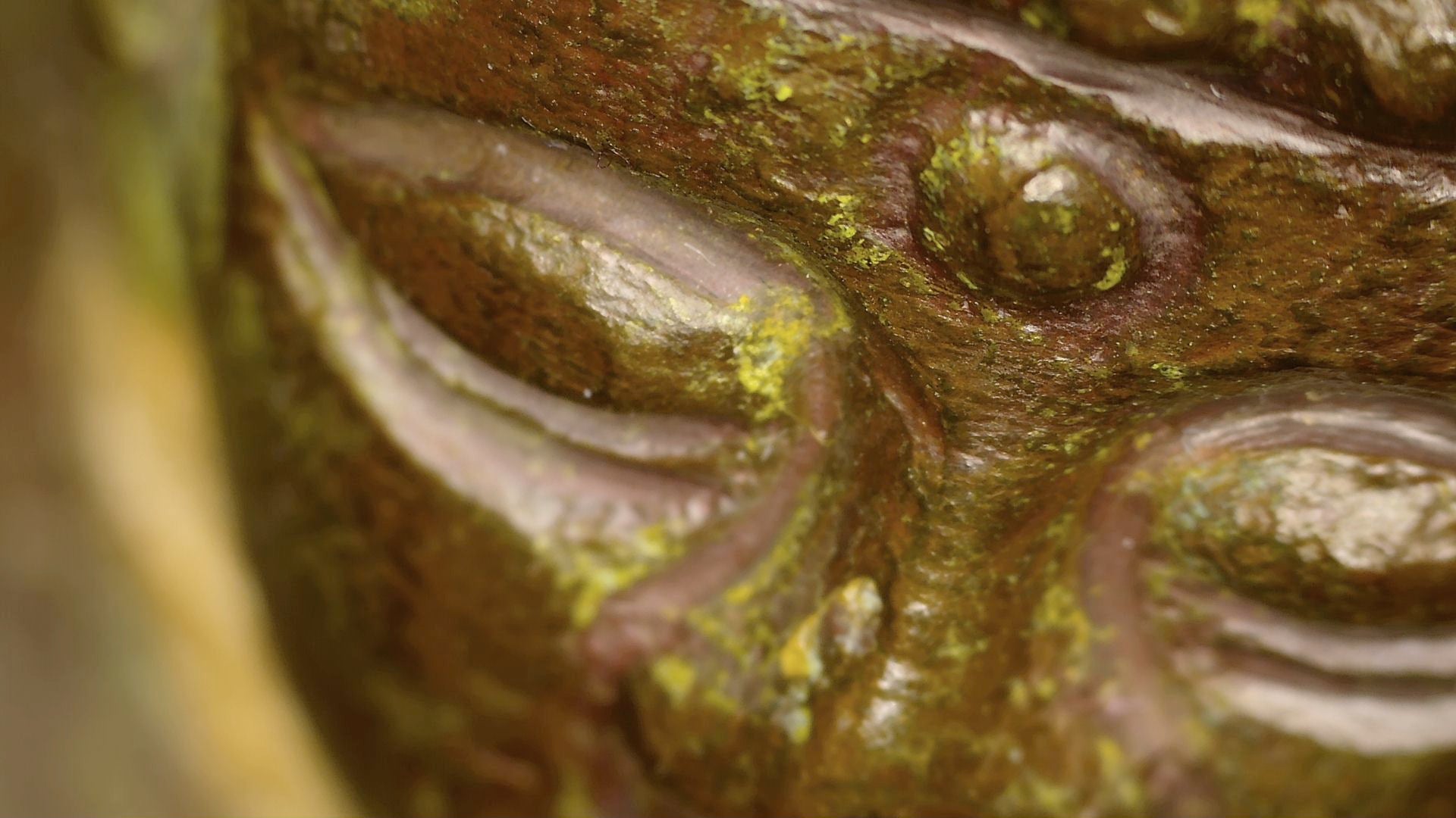Macro photograph of the Buddha’s eye, urna and aged patina