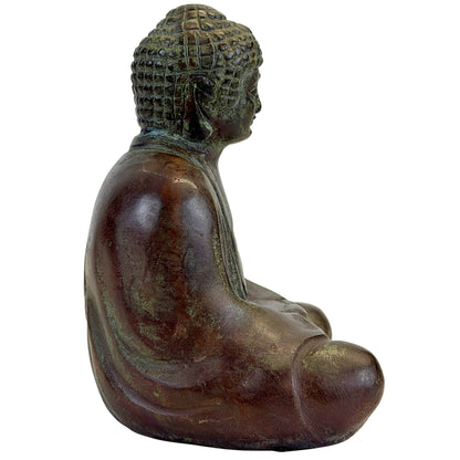 Right profile of the compact Japanese bronze Buddha in seated meditation