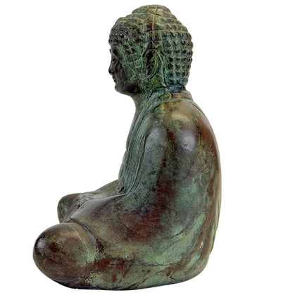 Left profile of the seated bronze Buddha with oxidized surface and patterned hair