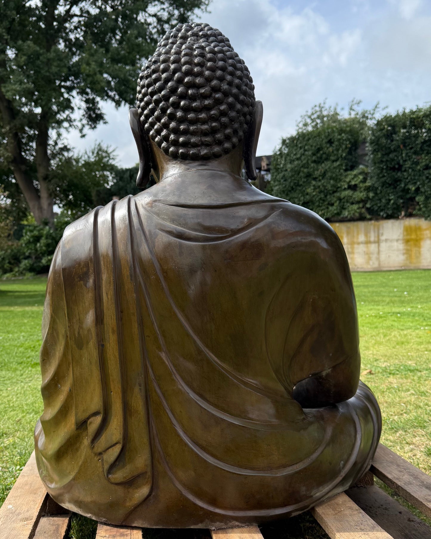 Large Japanese Amida Buddha in bronze shown outdoors