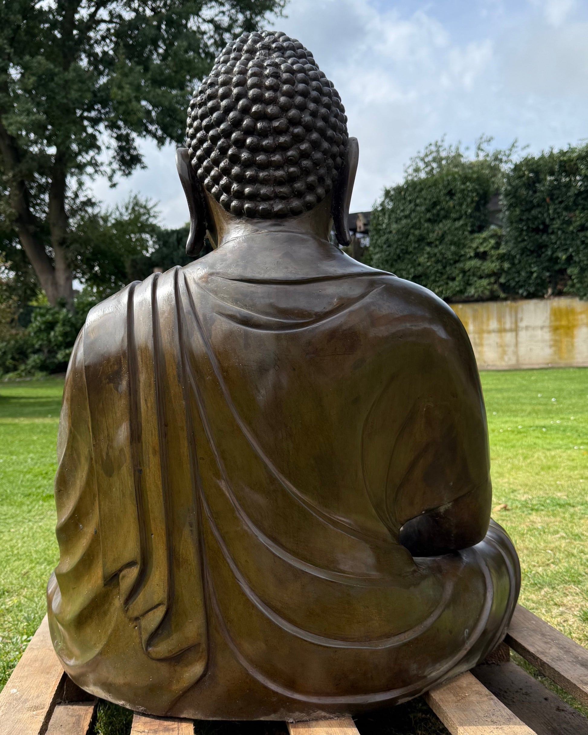 Large Japanese Amida Buddha in bronze shown outdoors