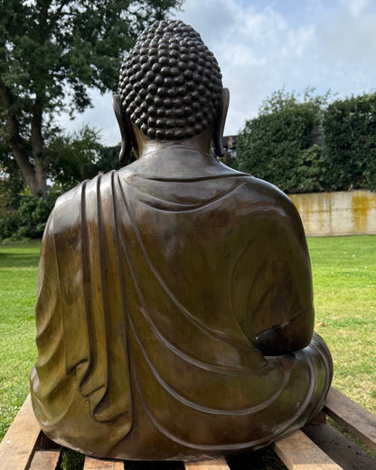 Large Japanese Amida Buddha in bronze shown outdoors