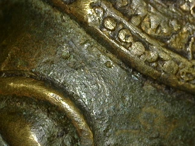 Close view of the patina and worn gilt surface