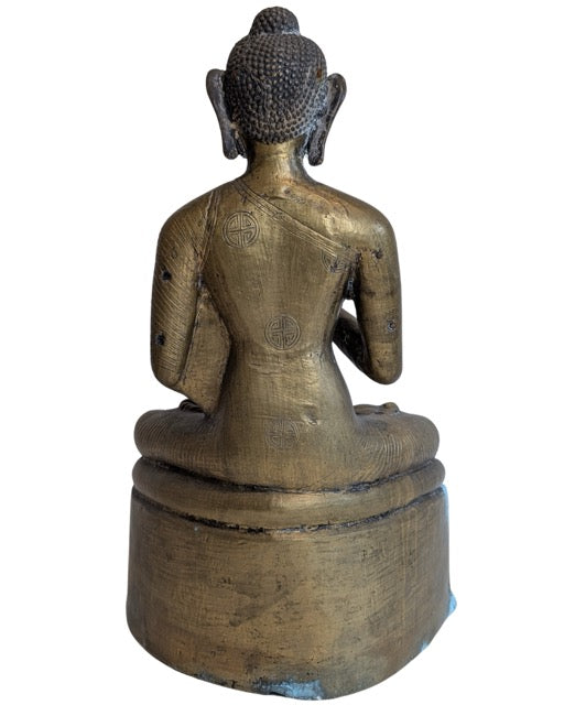 Ornate base with mythical figures beneath the seated Buddha