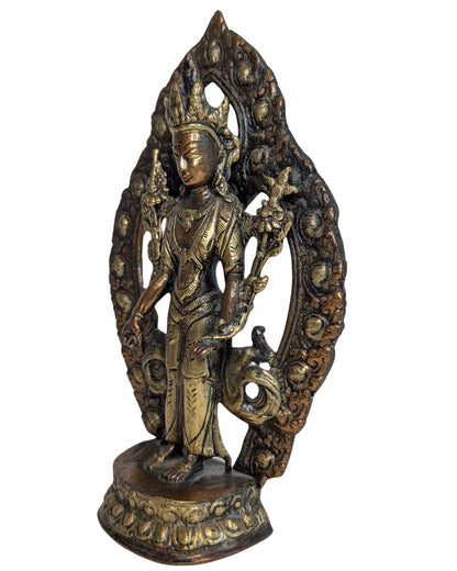 Tara holding lotus flowers beside the standing figure
