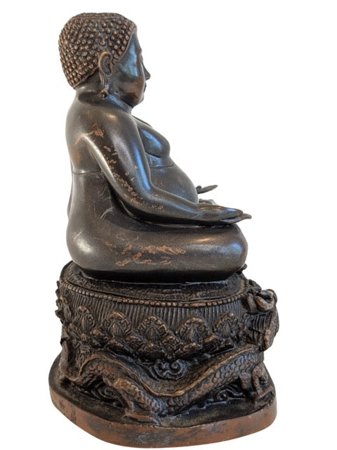 Dragon motifs carved into the bronze Buddha pedestal
