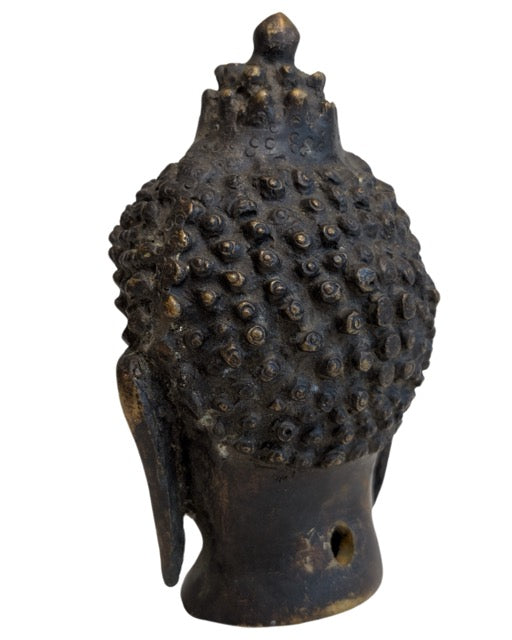 Opposite profile of the dark-patinated Buddha head