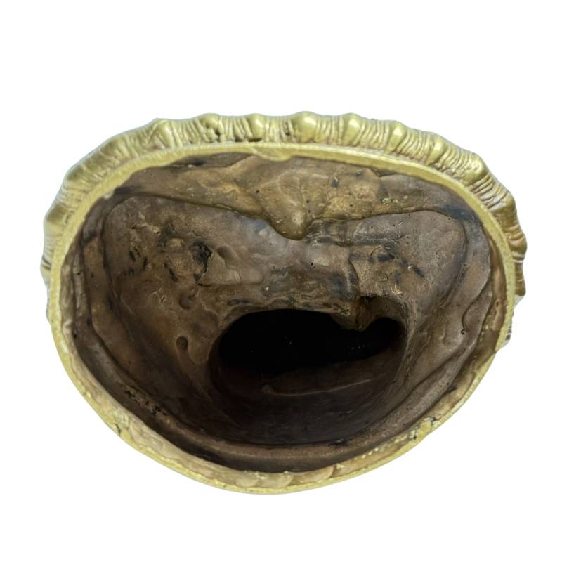 Open underside with visible casting core remnants inside the bronze Buddha