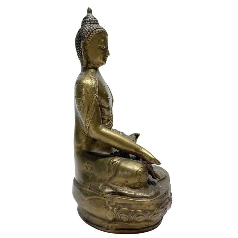 Side view of seated Chinese bronze Buddha on lotus base