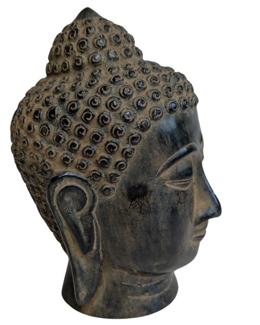 Serene facial features of the Southeast Asian bronze Buddha head