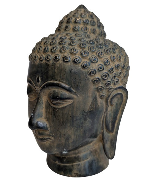 Close view of the Buddha head's curls and facial modelling
