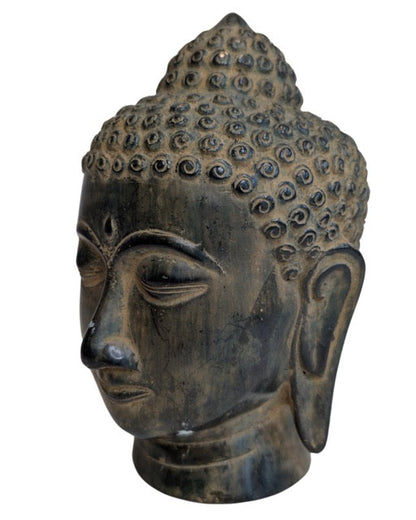 Close view of the Buddha head's curls and facial modelling