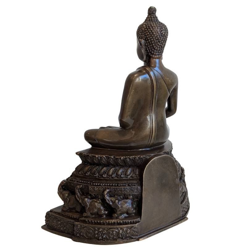 Opposite three-quarter rear view of the bronze Buddha and elephant throne