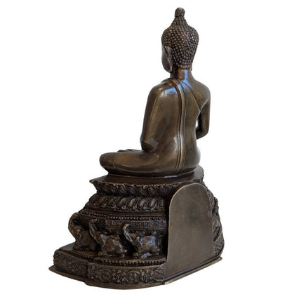 Opposite three-quarter rear view of the bronze Buddha and elephant throne