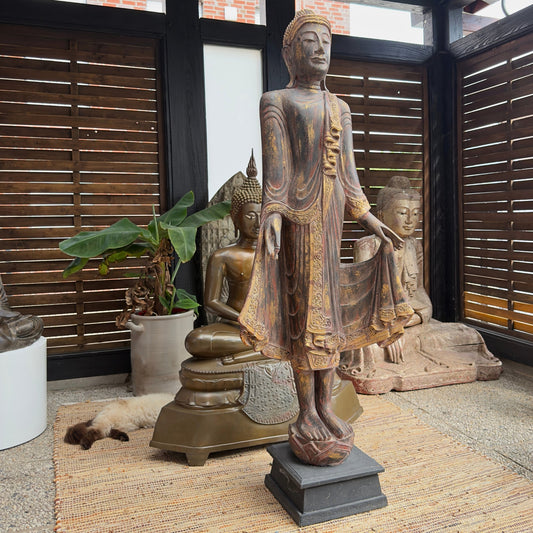 Overall view of the monumental 166 cm Burmese standing Buddha in carved teak