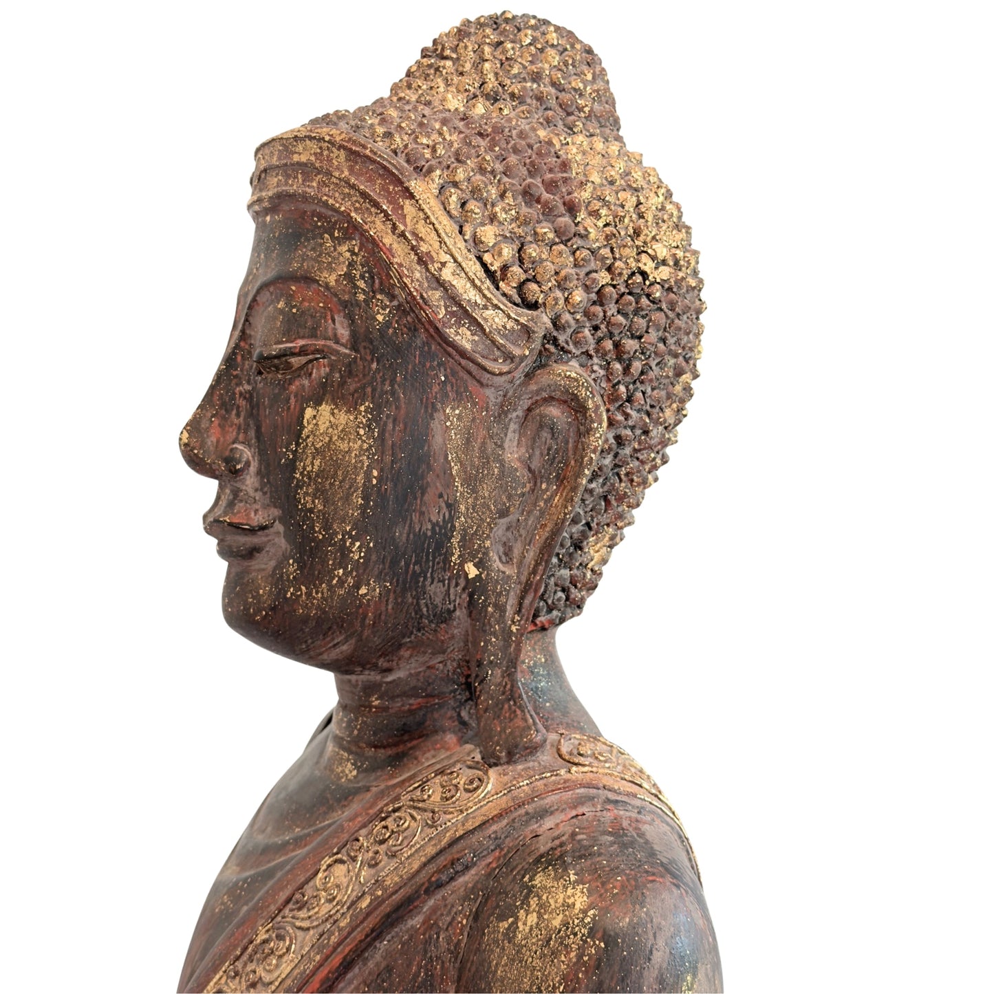 Profile view of the monumental Burmese standing Buddha in carved teak