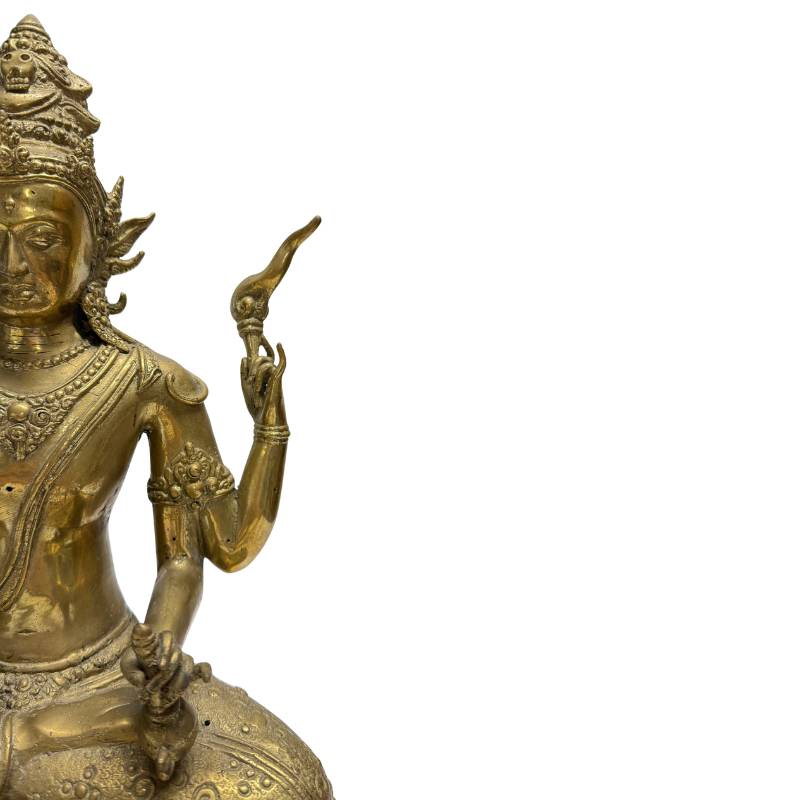 Detail of the right-side arms holding an oil lamp and flame-like ritual attribute