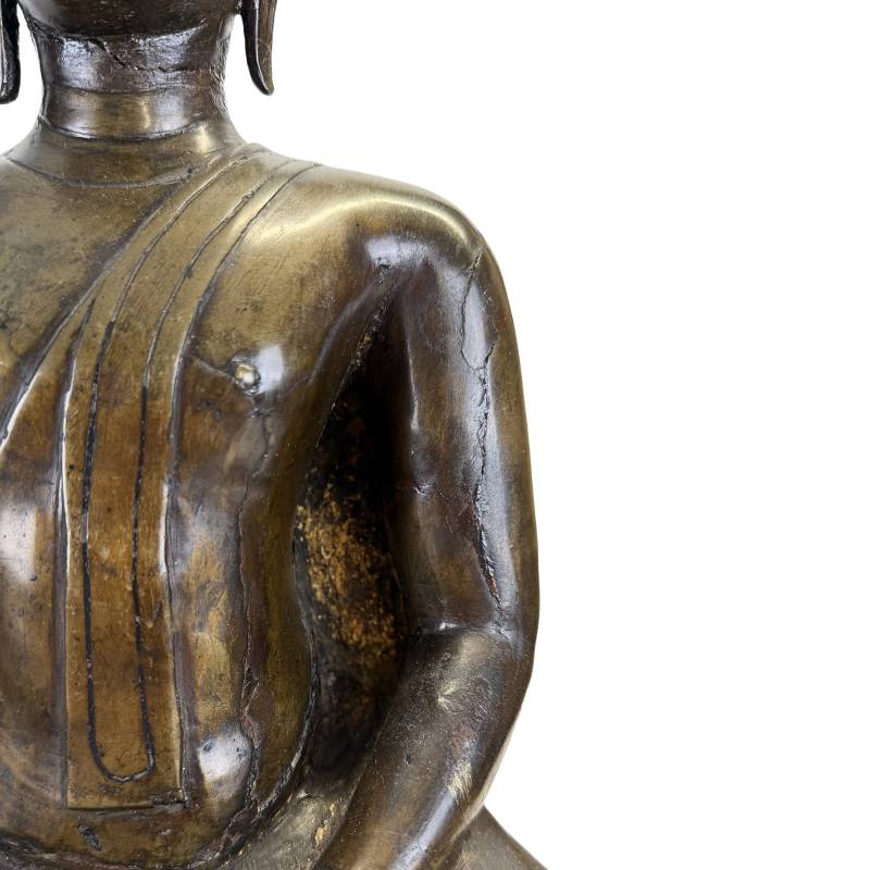 Arm and torso casting detail of the Northern Thai bronze Buddha showing historic fissures, irregular lost-wax surfaces and aged patina
