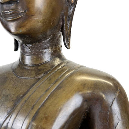 Neck and shoulder detail of an antique Northern Thai bronze Buddha showing the incised monastic robe and aged bronze patina