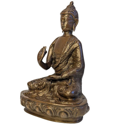 Front-left view of seated bronze Buddha in Vitarka Mudra on lotus base