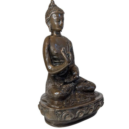 Front-right view of seated bronze Buddha in Vitarka Mudra on lotus base