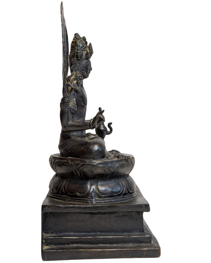 Right profile of four-armed bronze Vishnu seated on a lotus base with openwork aureole