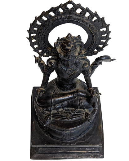 Top view of four-armed bronze Vishnu seated on the lotus base within the aureole