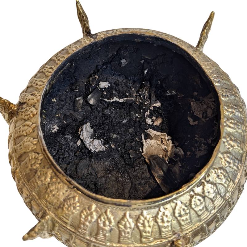 Bronze and gold-toned surface with devotional wear