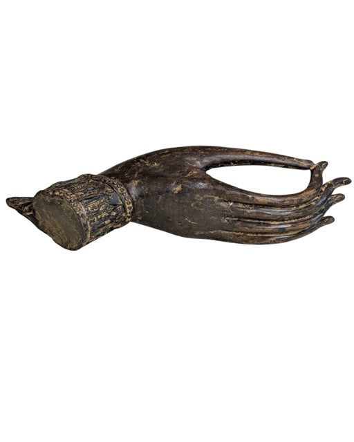 Old Southeast Asian bronze Buddha hand on a custom display stand