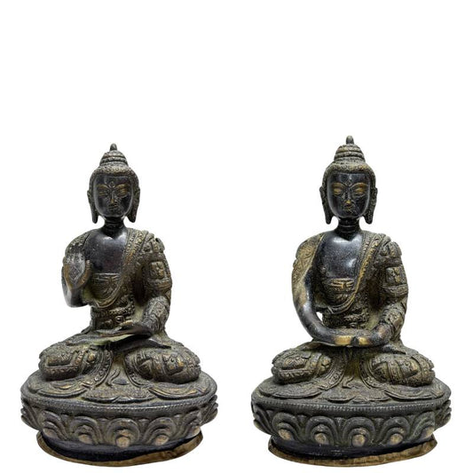 Pair of Nepalese fire-gilt bronze Buddhas on lotus bases, front view
