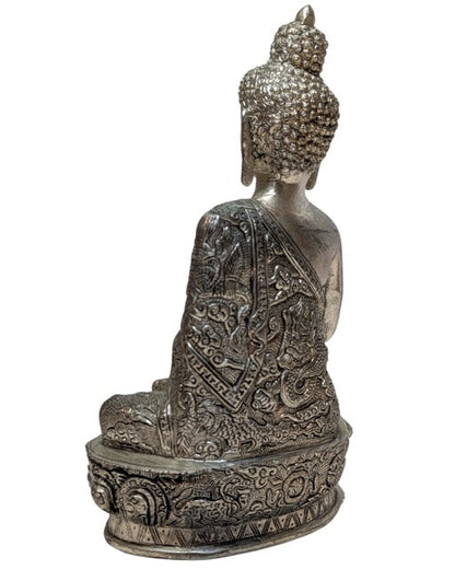 Deity and symbolic engravings on the silver-toned statue