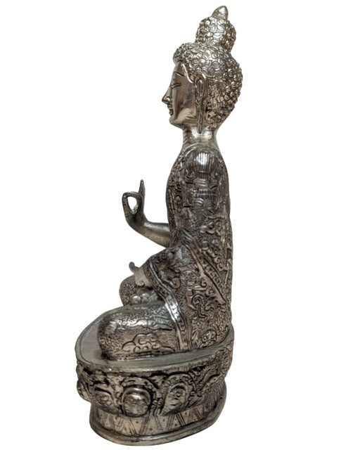 Dharma Wheel motif on the Nepalese alloy Buddha