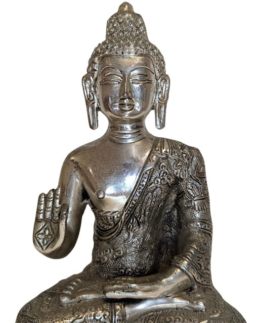Bright polished surface of the white-metal Buddha