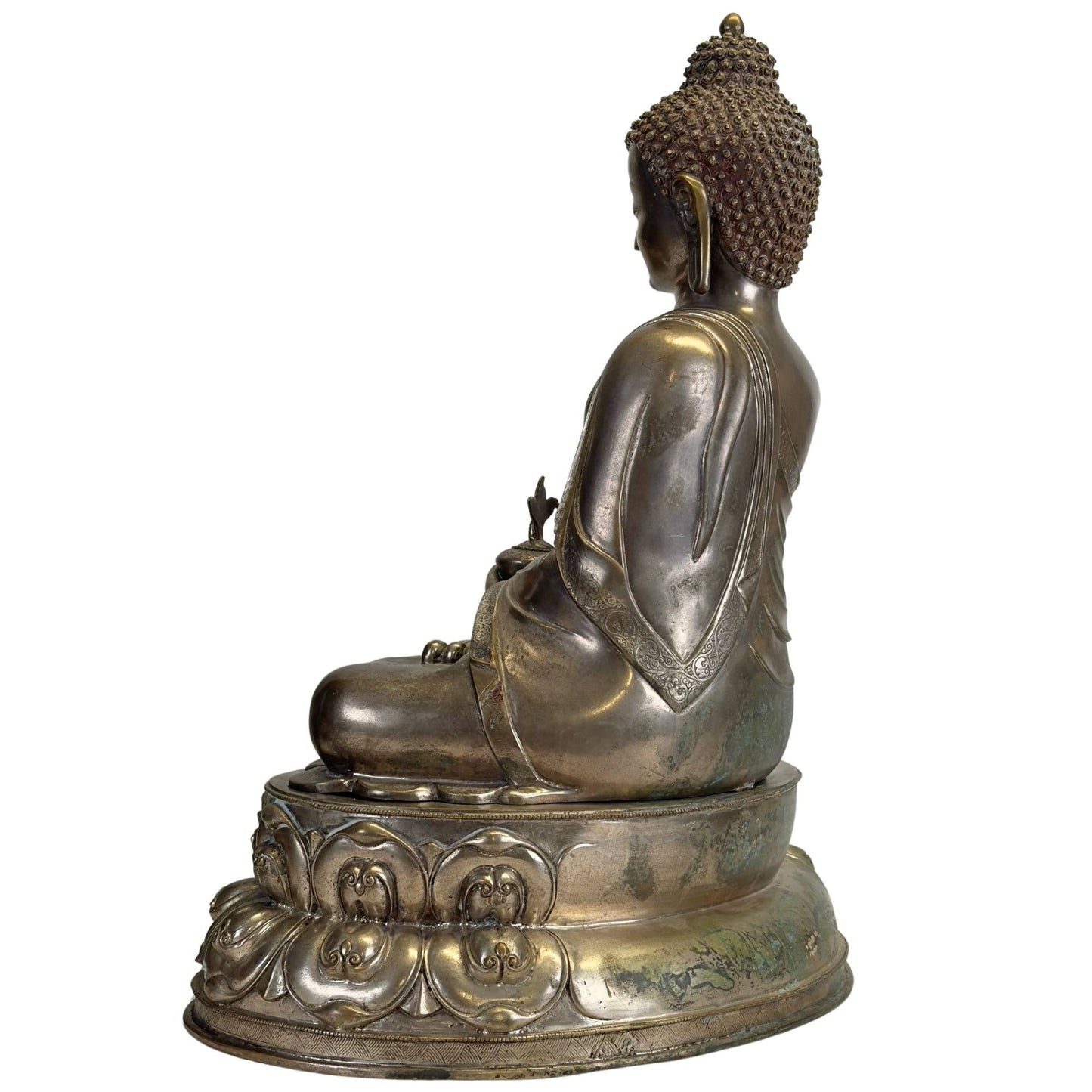 Left profile of the silvered Newar Bhaisajyaguru on its two-part lotus throne