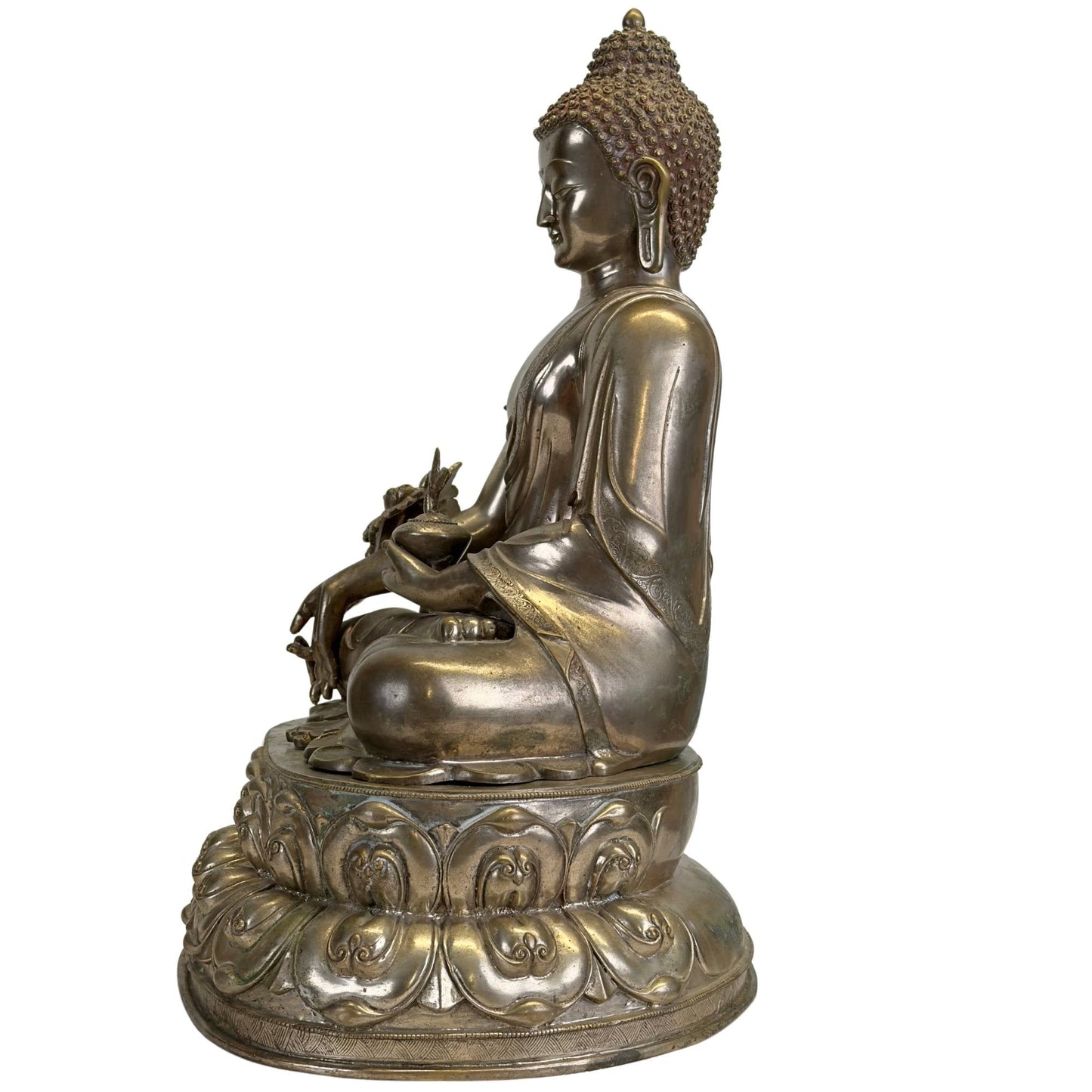 Right profile of the silvered Newar Bhaisajyaguru with medicine bowl and engraved robe
