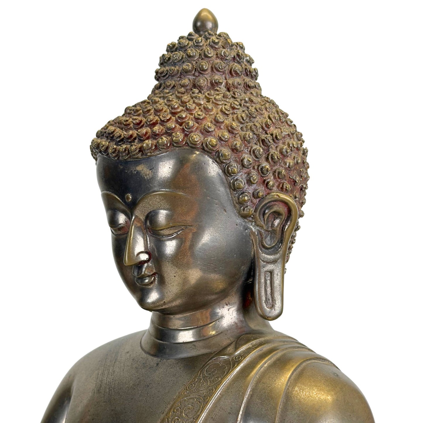 Three-quarter facial detail of the silvered Newar Bhaisajyaguru with long earlobes and curled hair