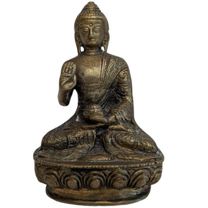 Raised right hand of the Nepalese bronze Buddha in Abhaya Mudra