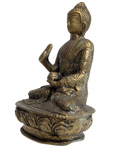 Detailed robe and raised Abhaya hand of the Nepalese Buddha