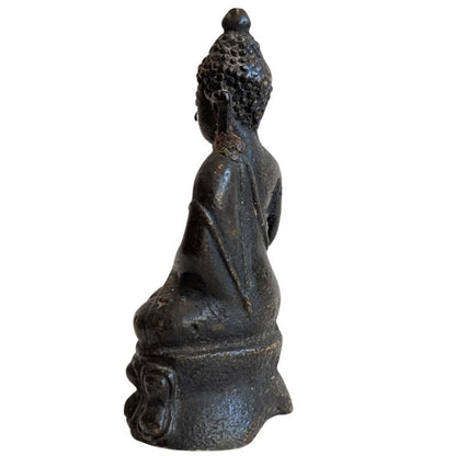 Rear-left view of the seated bronze Buddha with natural wear