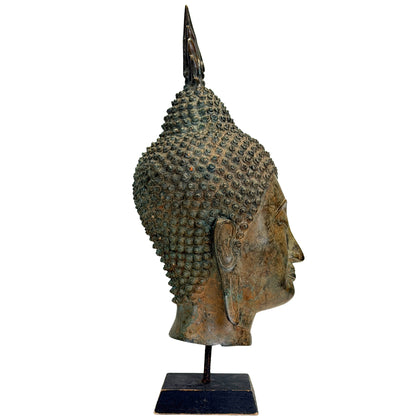 Thai bronze Buddha head with long earlobes and a serene facial expression