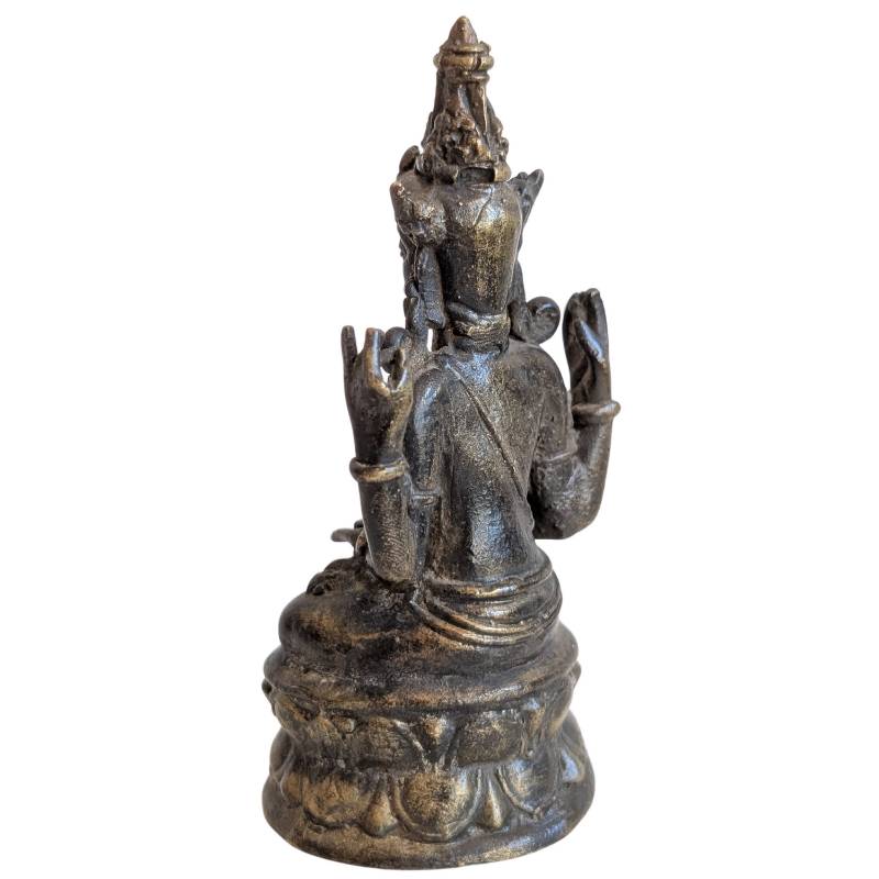Rear-left view of the crowned four-armed bodhisattva on a lotus base