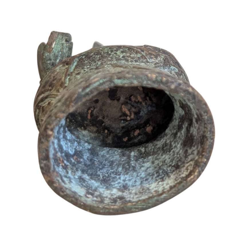 Open underside of the Thai bronze Buddha showing the hollow bell-shaped base
