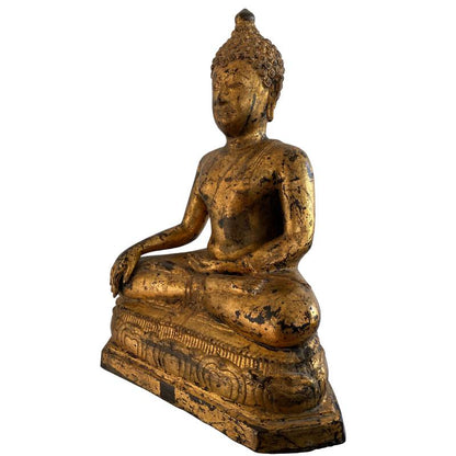 Left-front view of the fire-gilt bronze Buddha on its lotus pedestal