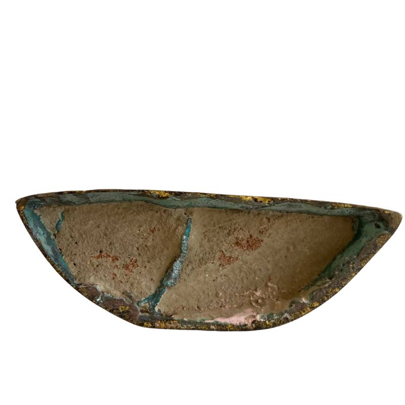 Sealed underside filled with ritual material and visible oxidation