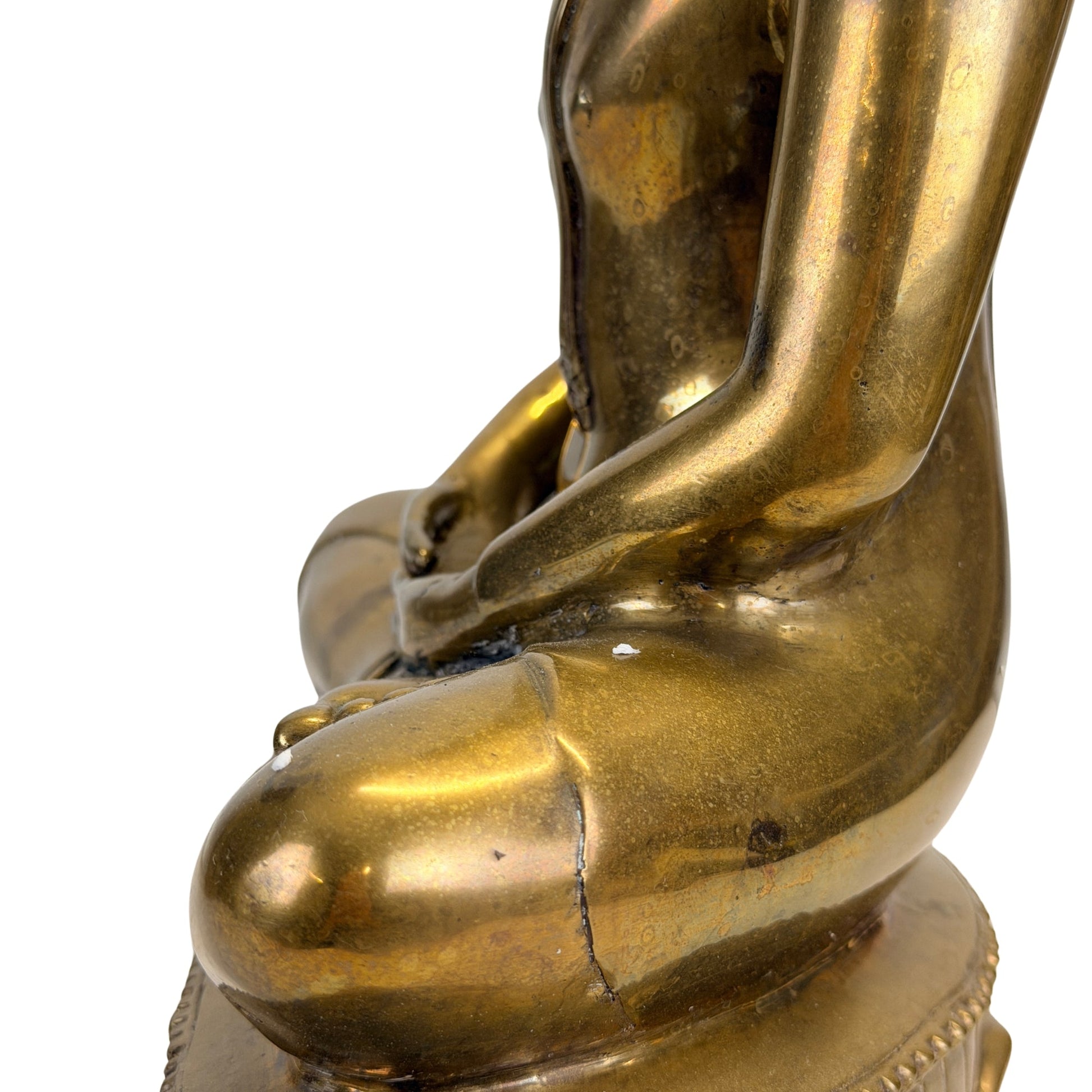 Arm, torso and historic surface detail on the 19th-century Thai Shakyamuni Buddha